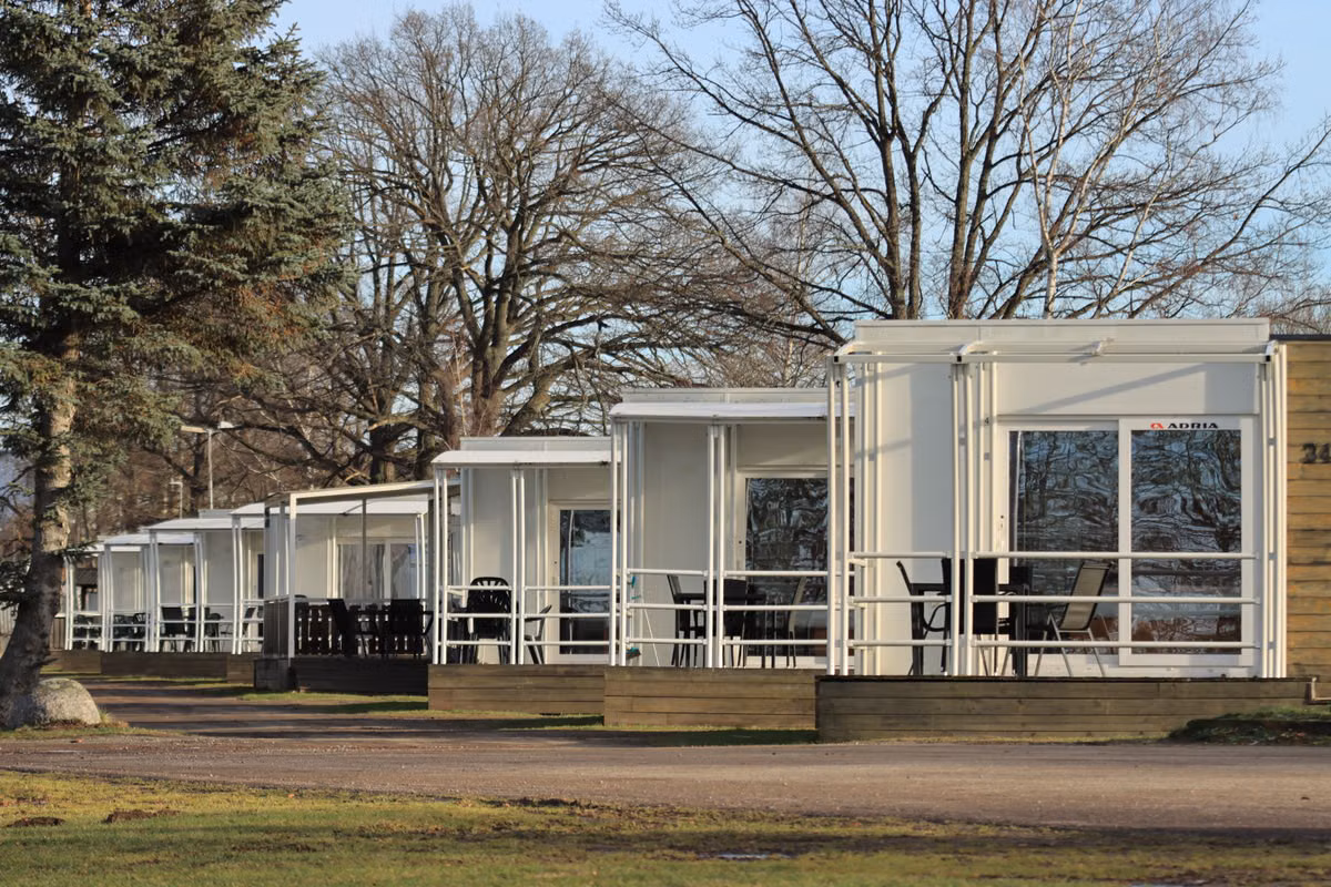 Row of modern cabins in a forest setting