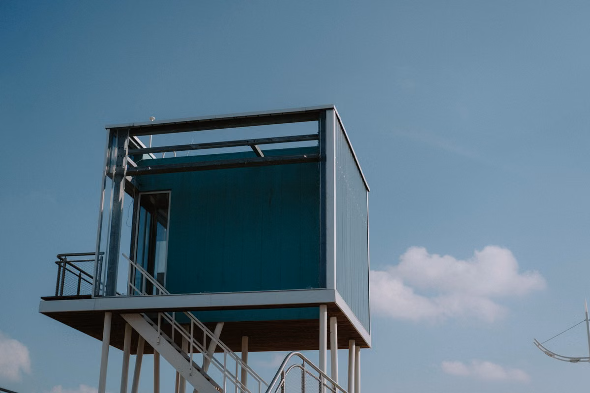 Minimalist elevated home against a clear sky